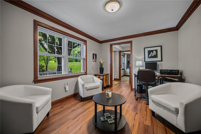 office area featuring baseboards, hardwood / wood-style floors, and crown molding