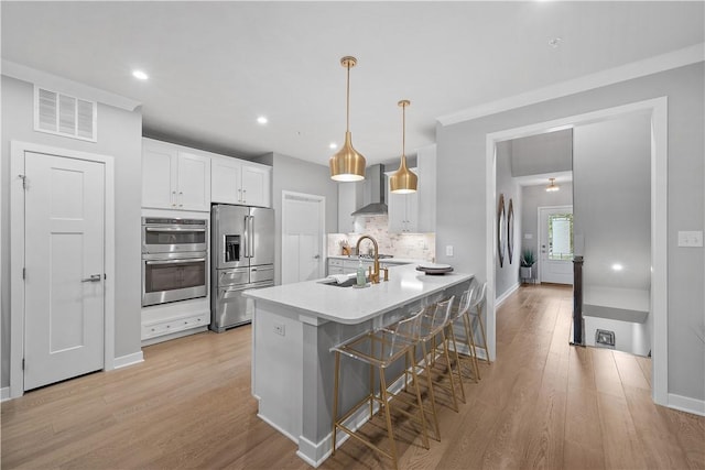 3033 Mahican Cir, Marshall, PA 16046 - kitchen with stainless steel appliances, a breakfast bar, a sink, wall chimney exhaust hood, and decorative backsplash