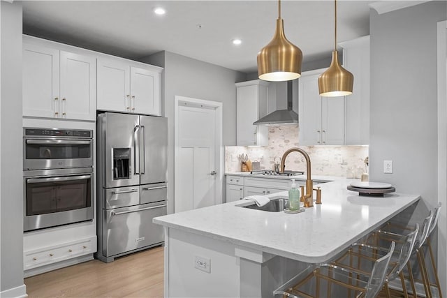 3033 Mahican Cir, Marshall, PA 16046 - kitchen featuring appliances with stainless steel finishes, wall chimney exhaust hood, a peninsula, white cabinets, and recessed lighting
