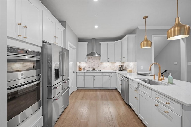 3033 Mahican Cir, Marshall, PA 16046 - kitchen with appliances with stainless steel finishes, wall chimney exhaust hood, a sink, a peninsula, and backsplash