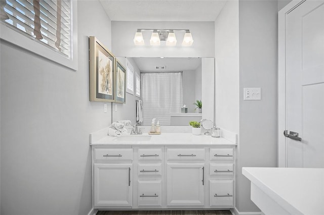 bathroom featuring vanity and baseboards