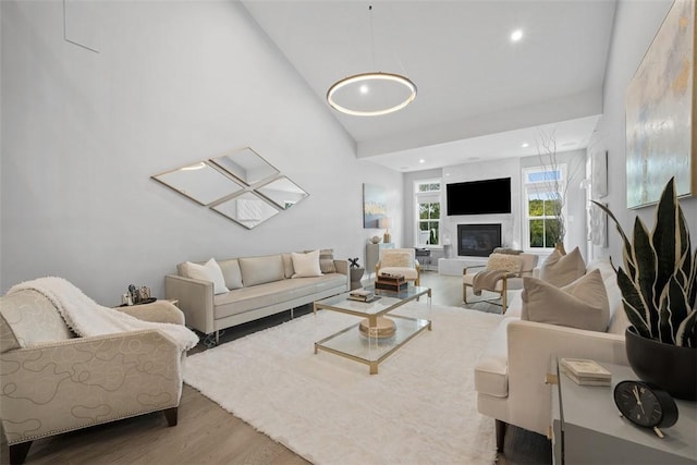 3033 Mahican Cir, Marshall, PA 16046 - living area with wood finished floors, recessed lighting, a glass covered fireplace, and high vaulted ceiling