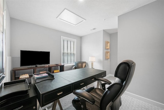 office space with attic access, baseboards, and carpet