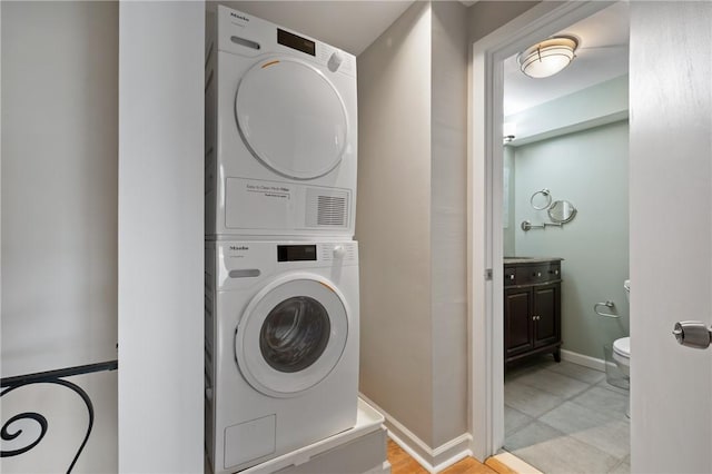 5708 Walnut Unit B2, Shadyside, PA 15232 - clothes washing area featuring stacked washing machine and dryer and baseboards