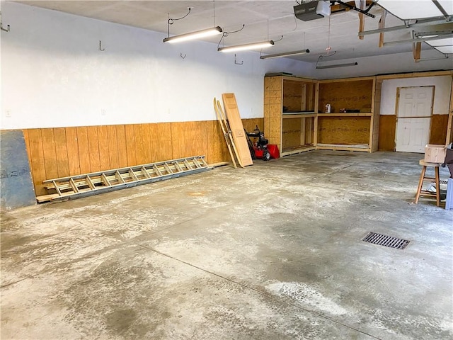 147 Crimson Oak Rd, Jefferson Twp Som, PA 15501 - garage with a garage door opener, wood walls, and a wainscoted wall