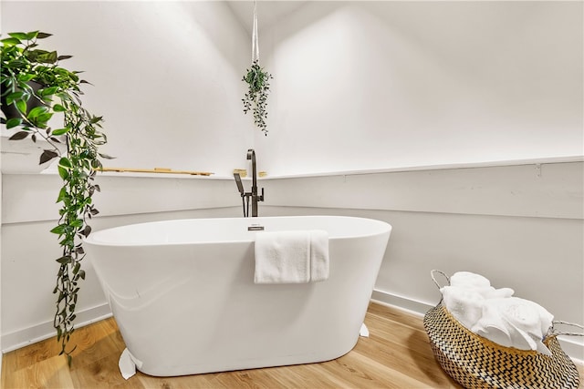 147 Crimson Oak Rd, Jefferson Twp Som, PA 15501 - bathroom view of a soaking tub, wood finished floors, and baseboards