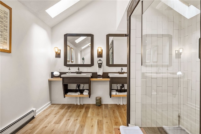 147 Crimson Oak Rd, Jefferson Twp Som, PA 15501 - bathroom featuring a skylight, a baseboard radiator, wood finished floors, lofted ceiling, and tiled shower