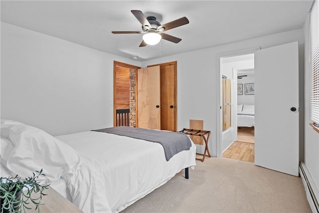 147 Crimson Oak Rd, Jefferson Twp Som, PA 15501 - bedroom featuring a baseboard radiator, light carpet, a ceiling fan, and connected bathroom