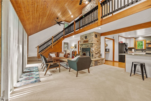 147 Crimson Oak Rd, Jefferson Twp Som, PA 15501 - living area with high vaulted ceiling, a ceiling fan, stairs, a fireplace, and light carpet