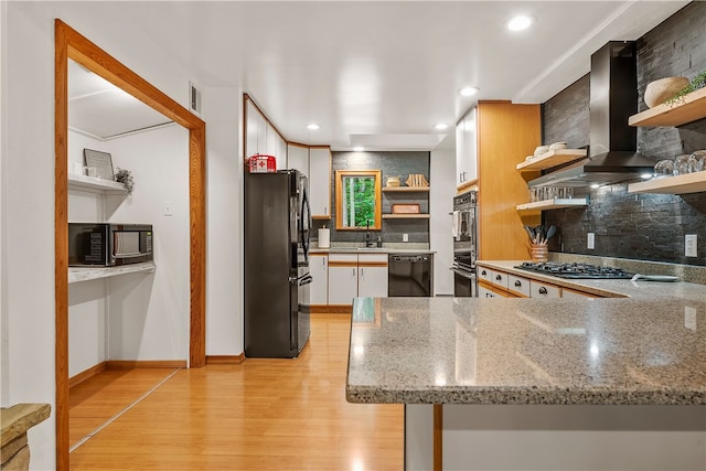 147 Crimson Oak Rd, Jefferson Twp Som, PA 15501 - kitchen featuring open shelves, black appliances, wall chimney exhaust hood, light wood-style flooring, and tasteful backsplash