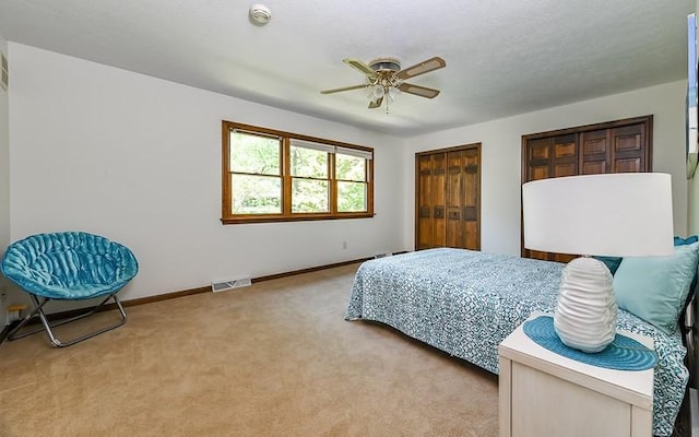 carpeted bedroom with baseboards and ceiling fan