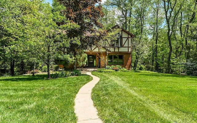 view of front of home featuring a front lawn and brick siding