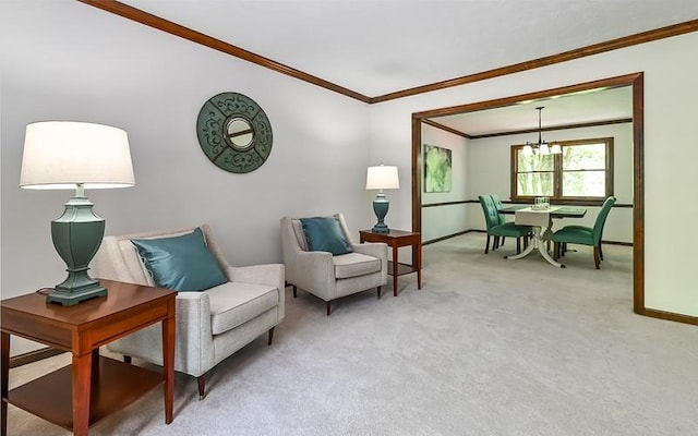 living area featuring ornamental molding, baseboards, light carpet, and a chandelier