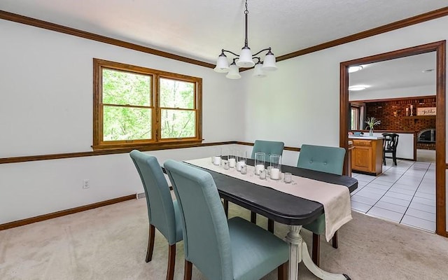 dining area featuring light carpet, a chandelier, baseboards, and crown molding