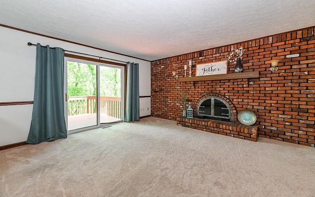 unfurnished living room featuring carpet floors, baseboards, ornamental molding, a textured ceiling, and a fireplace
