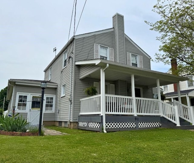 911 Columbia Ave, Grove City Boro, PA 16127 - view of home's exterior with covered porch, a yard, and a chimney