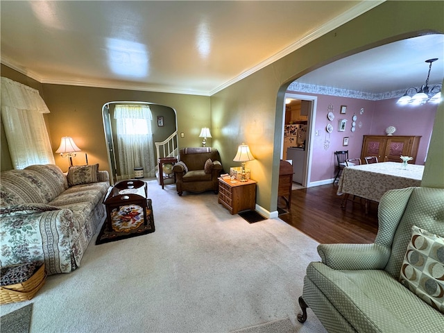 911 Columbia Ave, Grove City Boro, PA 16127 - carpeted living area featuring arched walkways, ornamental molding, baseboards, and a chandelier