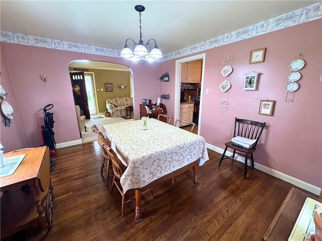 911 Columbia Ave, Grove City Boro, PA 16127 - dining space featuring arched walkways, wood finished floors, and baseboards
