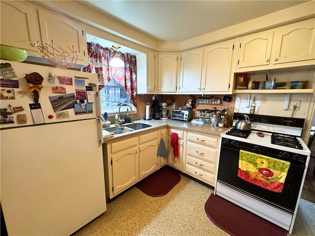 911 Columbia Ave, Grove City Boro, PA 16127 - kitchen with freestanding refrigerator, gas range oven, a sink, light countertops, and open shelves