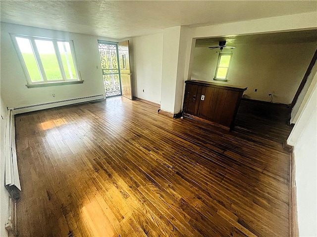 128 Cessna Hill Rd, Jenner Twp, PA 15531 - unfurnished living room featuring baseboard heating, wood-type flooring, baseboards, and ceiling fan