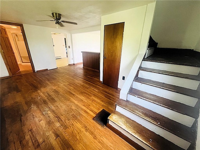 128 Cessna Hill Rd, Jenner Twp, PA 15531 - staircase featuring wood finished floors, ceiling fan, and a baseboard radiator
