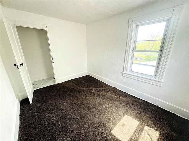 128 Cessna Hill Rd, Jenner Twp, PA 15531 - spare room featuring baseboards and dark carpet