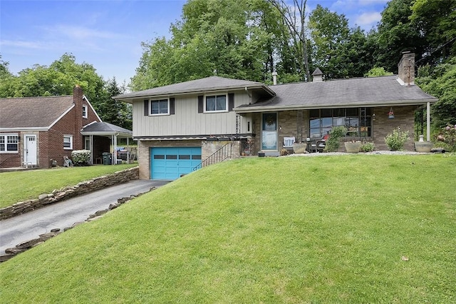426 Oliver Dr, White Oak, PA 15131 - tri-level home featuring covered porch, driveway, brick siding, and a front yard