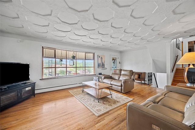 426 Oliver Dr, White Oak, PA 15131 - living room featuring baseboard heating, wood finished floors, and stairs