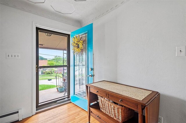 426 Oliver Dr, White Oak, PA 15131 - entryway with baseboard heating, light wood-style floors, and a textured ceiling