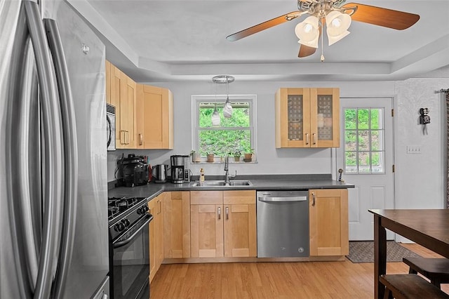 426 Oliver Dr, White Oak, PA 15131 - kitchen with stainless steel appliances, a sink, light brown cabinetry, and dark countertops