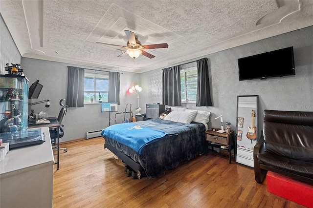 426 Oliver Dr, White Oak, PA 15131 - bedroom with a baseboard radiator, wood finished floors, a textured ceiling, ceiling fan, and ornamental molding