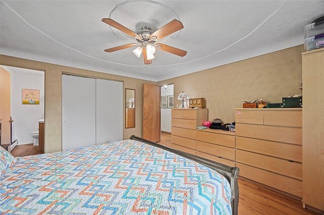 426 Oliver Dr, White Oak, PA 15131 - bedroom featuring wood finished floors, ceiling fan, baseboard heating, and a closet