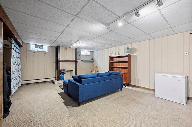 426 Oliver Dr, White Oak, PA 15131 - carpeted living room with baseboard heating, wood walls, track lighting, and a drop ceiling
