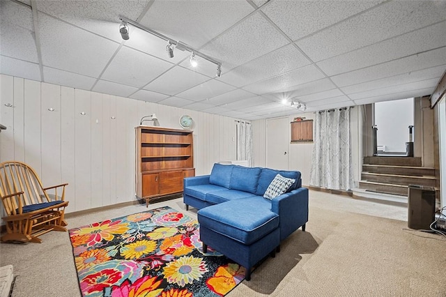 426 Oliver Dr, White Oak, PA 15131 - carpeted living area featuring track lighting, stairway, a paneled ceiling, and wooden walls