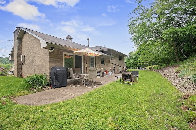 426 Oliver Dr, White Oak, PA 15131 - back of property featuring a patio area, a yard, and brick siding