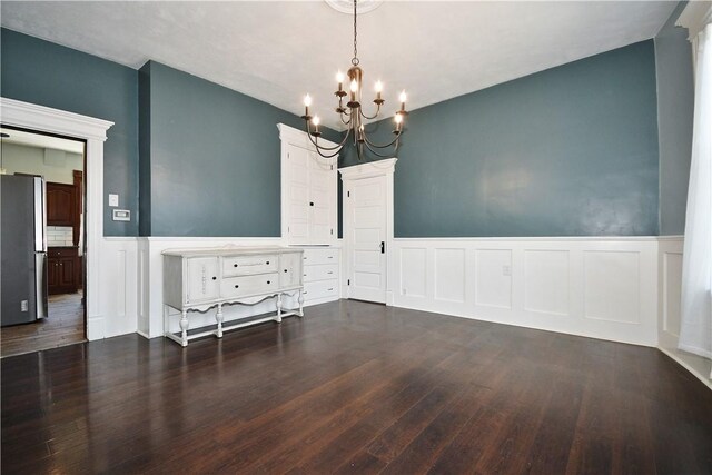 918 Arlington Prt, Vue, PA 15133 - unfurnished dining area featuring a chandelier, a decorative wall, wainscoting, and wood finished floors