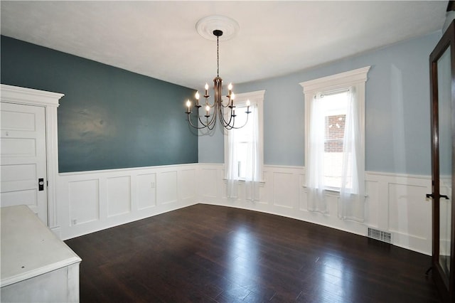918 Arlington Prt, Vue, PA 15133 - unfurnished dining area with a chandelier, wainscoting, dark wood-style flooring, and a decorative wall