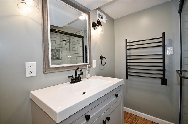 918 Arlington Prt, Vue, PA 15133 - full bathroom featuring vanity, wood finished floors, a towel warming rack, and a tile shower