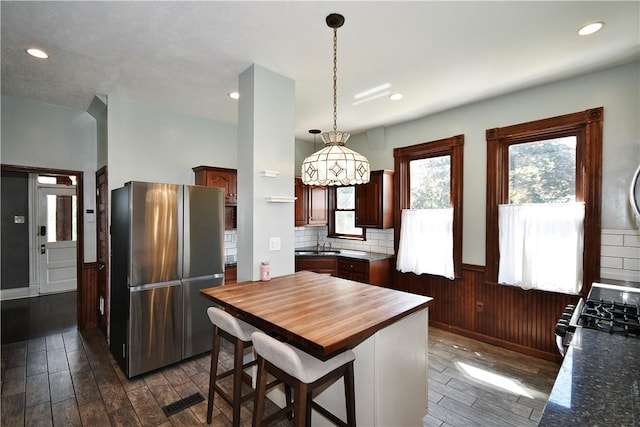 918 Arlington Prt, Vue, PA 15133 - kitchen with freestanding refrigerator, butcher block countertops, dark wood-style flooring, range with gas stovetop, and a wainscoted wall