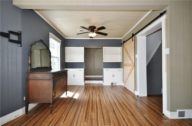 918 Arlington Prt, Vue, PA 15133 - unfurnished bedroom featuring a barn door, wood finished floors, crown molding, baseboards, and wallpapered walls