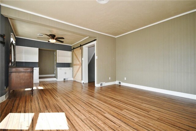 918 Arlington Prt, Vue, PA 15133 - unfurnished living room with a barn door, wood finished floors, a ceiling fan, ornamental molding, and baseboards