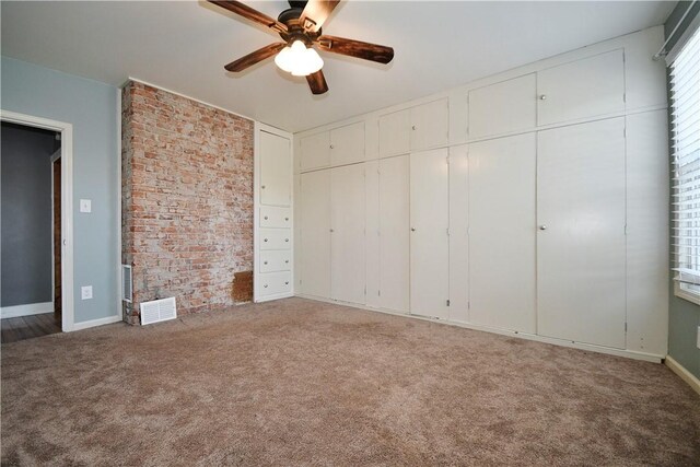918 Arlington Prt, Vue, PA 15133 - unfurnished bedroom with carpet floors, brick wall, baseboards, and a ceiling fan