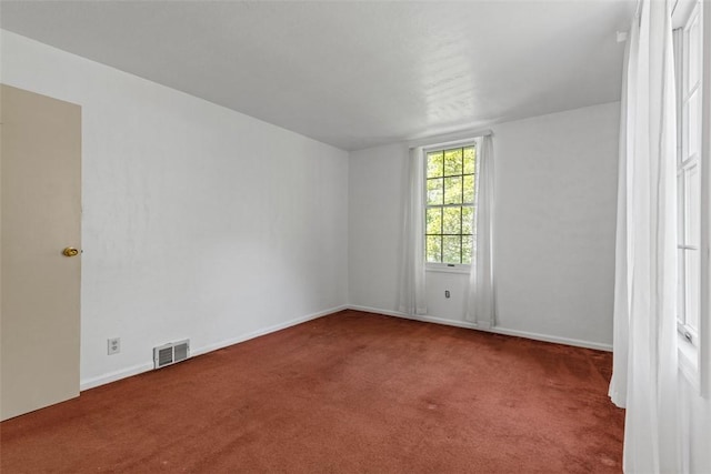 empty room with carpet flooring and baseboards