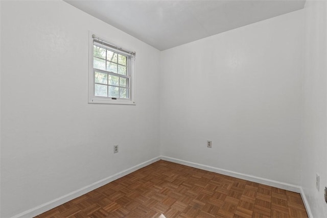 spare room with baseboards