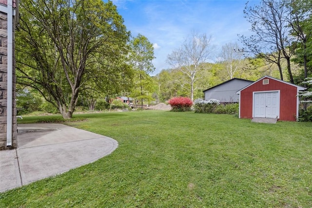 view of grassy yard featuring a storage shed and an outbuilding
