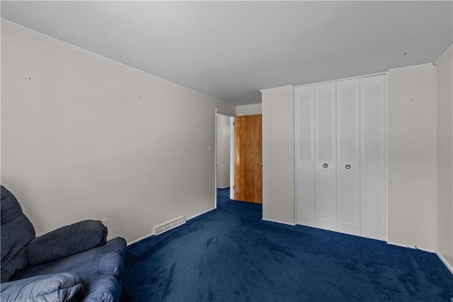 unfurnished bedroom featuring dark carpet, a closet, and crown molding