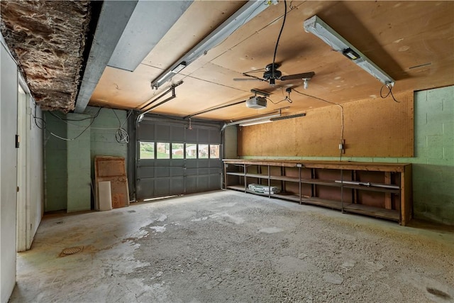 garage with a garage door opener and concrete block wall