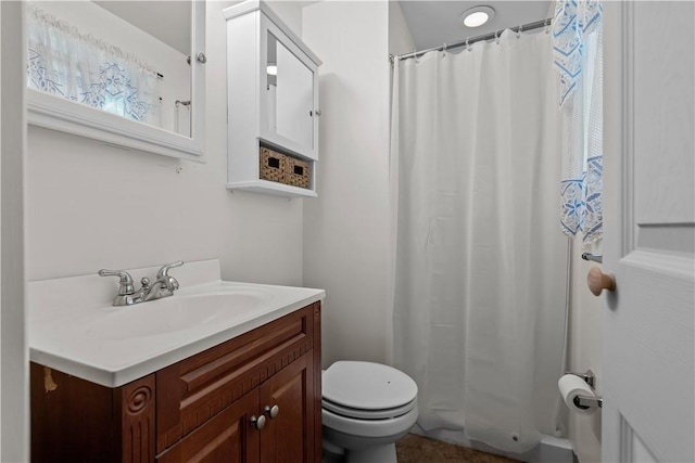 bathroom featuring toilet, a shower with curtain, and vanity