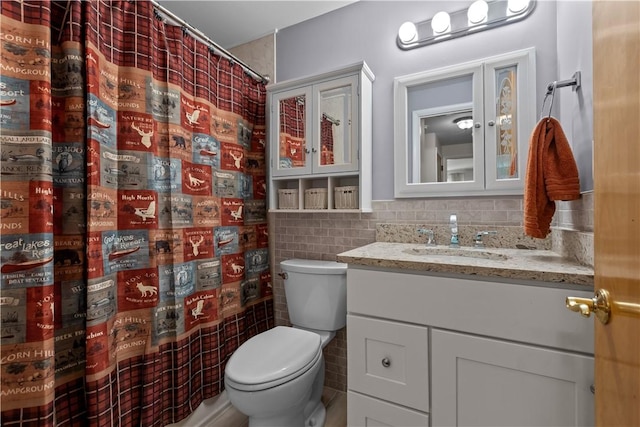 bathroom featuring toilet, vanity, tile walls, and a shower with curtain