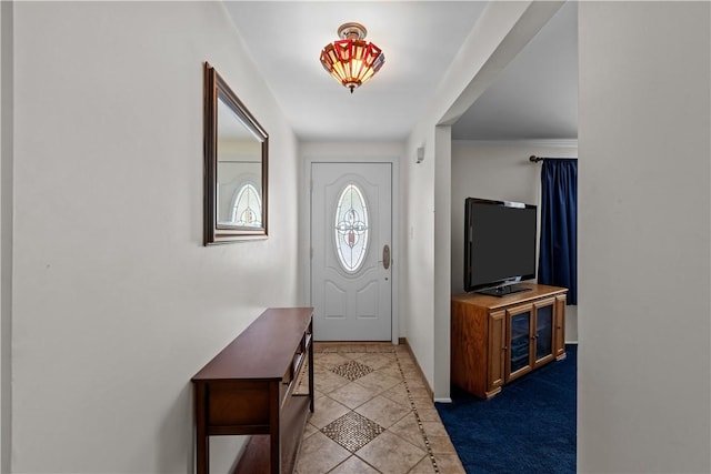 foyer entrance featuring tile patterned flooring and baseboards